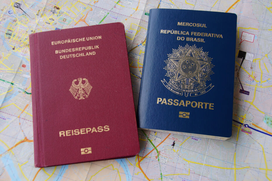 Foto colorida exibindo passaporteda Alemanha à esquerda e passaporte do Brasil à direita.